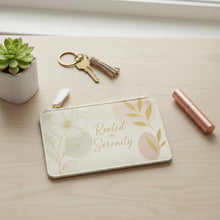 Load image into Gallery viewer, Beige pouch with floral designs and 'Rooted in Serenity' text on a white background
