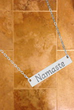 Load image into Gallery viewer, Silver necklace with a bar pendant engraved with 'Namaste'
